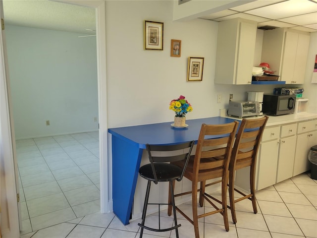 kitchen featuring white cabinets and light tile patterned floors