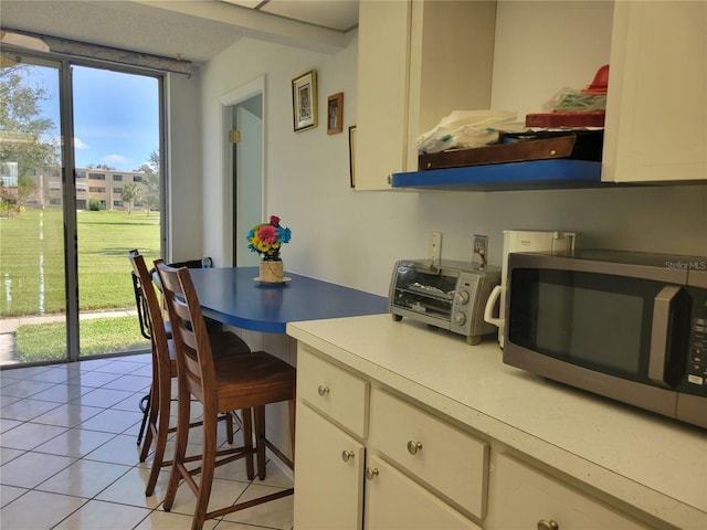 kitchen with light tile patterned floors and a breakfast bar