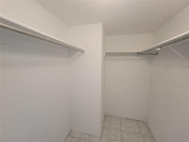 spacious closet featuring light tile patterned floors