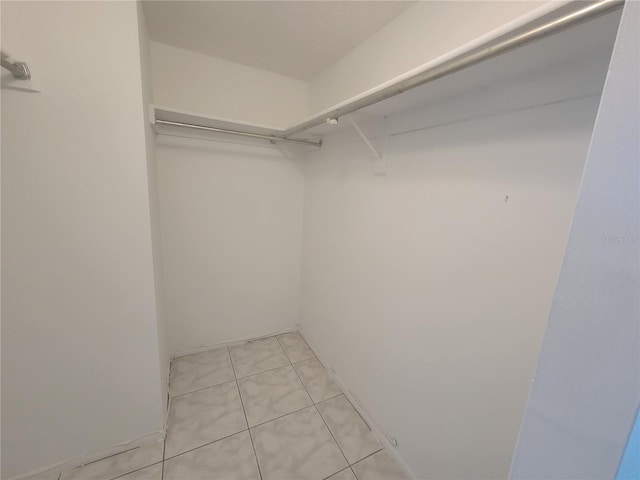 spacious closet with light tile patterned flooring