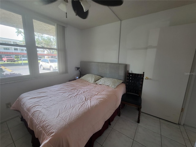 tiled bedroom with ceiling fan