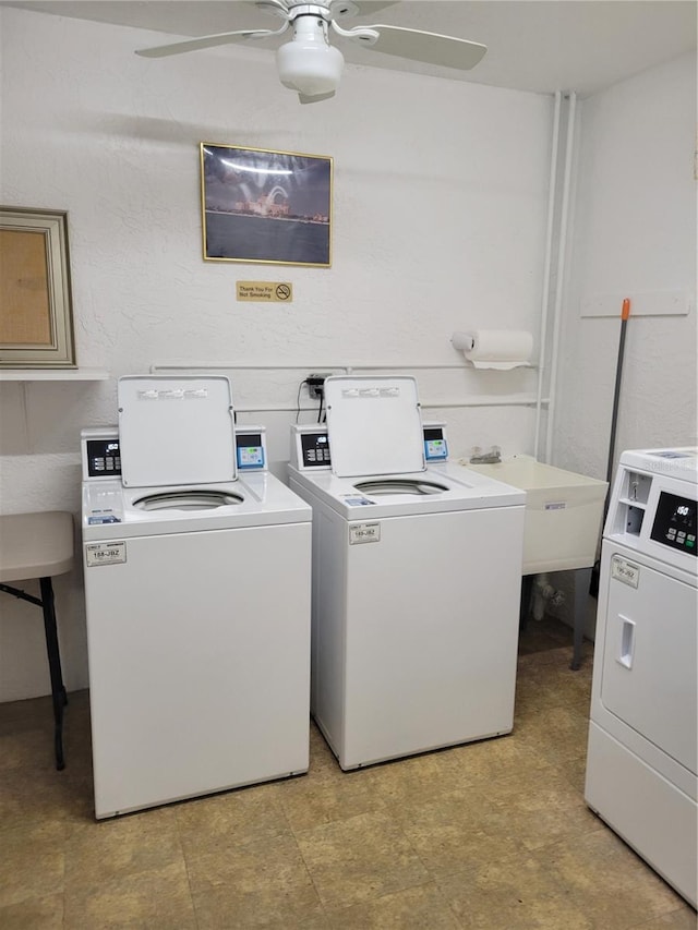 clothes washing area with ceiling fan, washer and clothes dryer, and sink