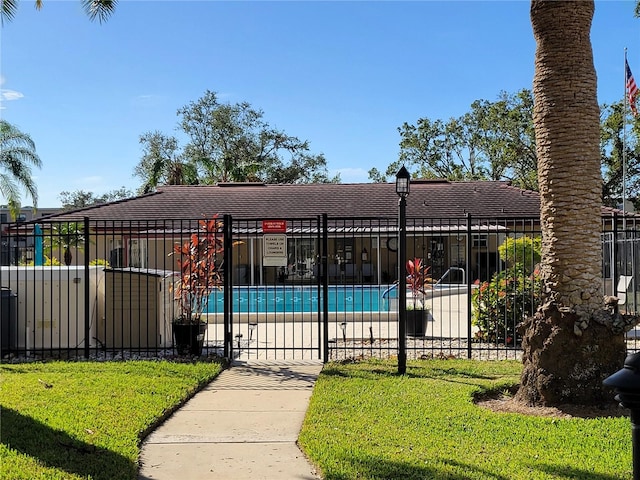 view of swimming pool with a lawn