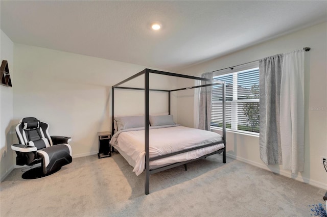 bedroom featuring light colored carpet