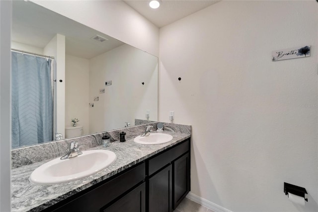 bathroom with toilet and vanity