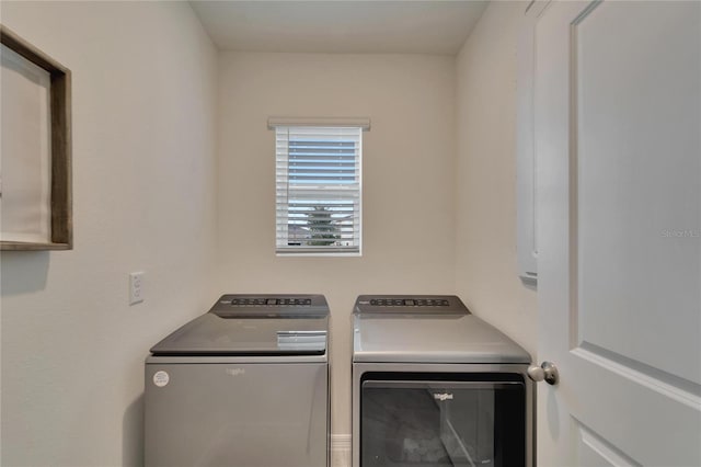 laundry room featuring washing machine and clothes dryer