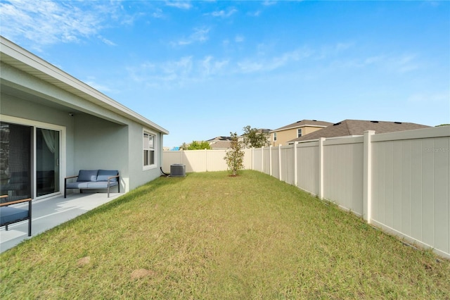 view of yard featuring cooling unit and a patio