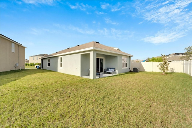 back of property with cooling unit, a lawn, and a patio