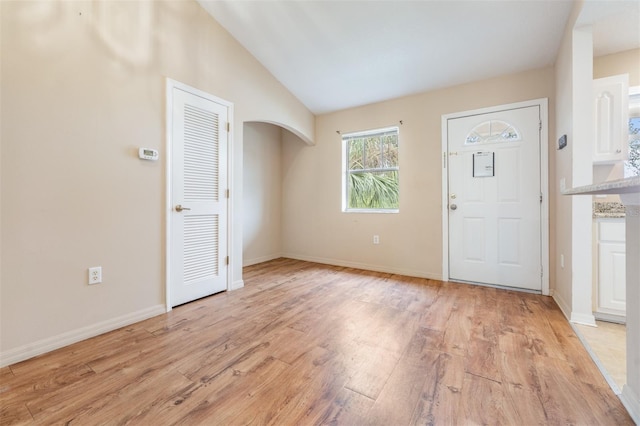 foyer featuring vaulted ceiling and light wood-type flooring