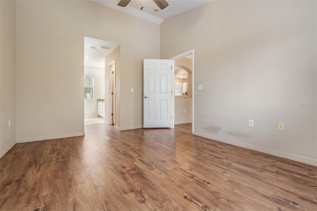 unfurnished room featuring ceiling fan, hardwood / wood-style flooring, and a textured ceiling