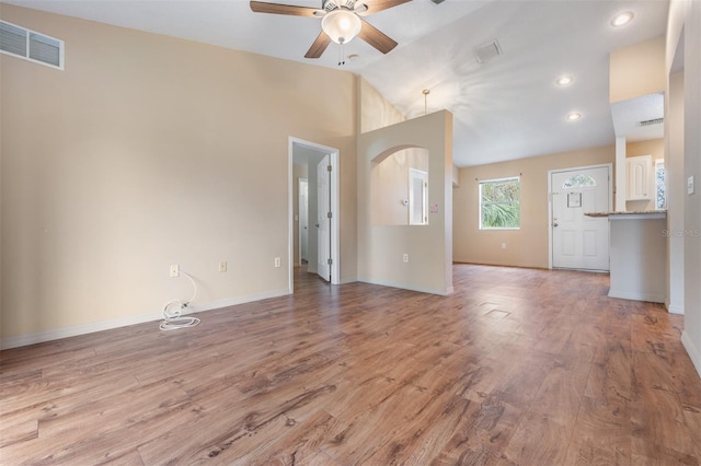 unfurnished living room featuring ceiling fan, light hardwood / wood-style flooring, and high vaulted ceiling