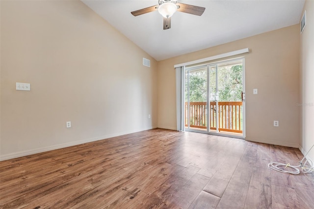 spare room featuring ceiling fan, vaulted ceiling, and light wood-type flooring