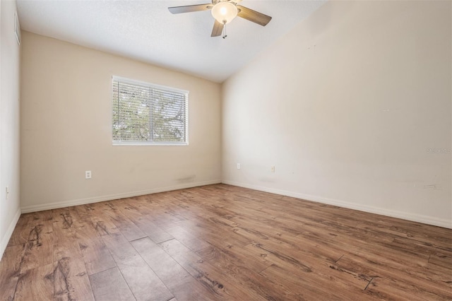 unfurnished room featuring ceiling fan, hardwood / wood-style floors, and lofted ceiling