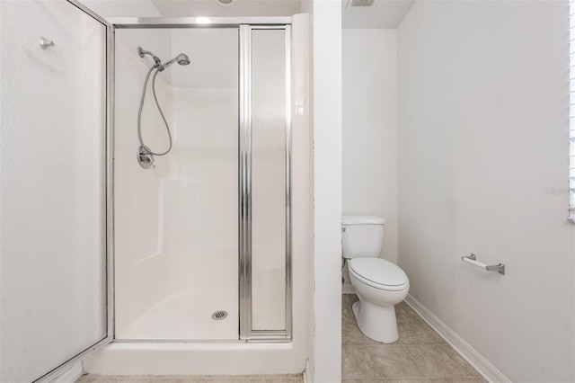 bathroom featuring an enclosed shower, toilet, and tile patterned floors