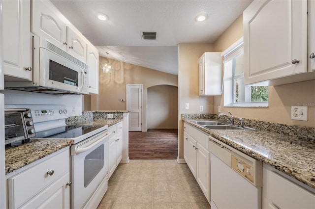 kitchen featuring white appliances, white cabinets, sink, and light wood-type flooring