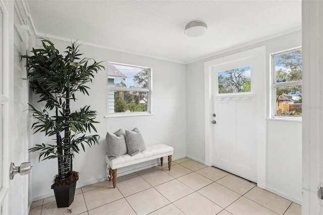 tiled foyer featuring ornamental molding