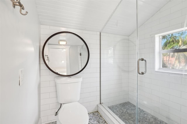 bathroom featuring walk in shower, tile walls, vaulted ceiling, and toilet