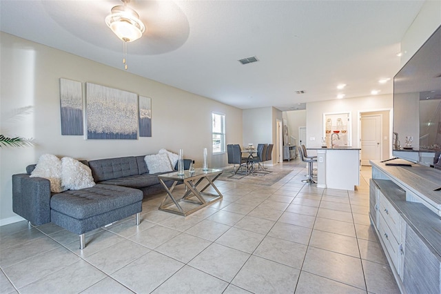 living room featuring light tile patterned floors and ceiling fan