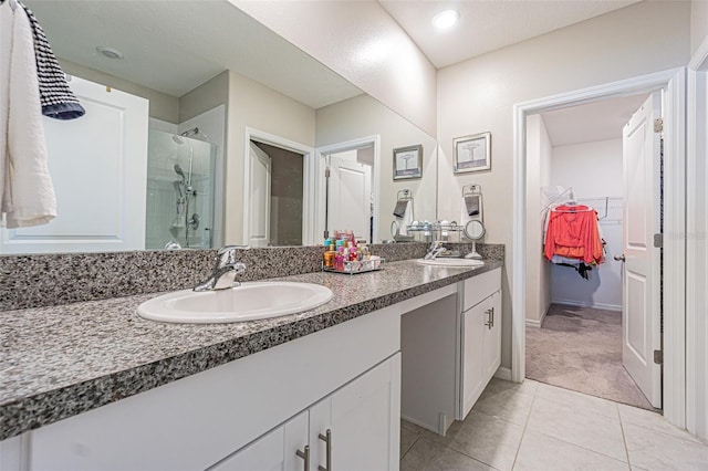 bathroom with tile patterned floors, vanity, and a shower with door