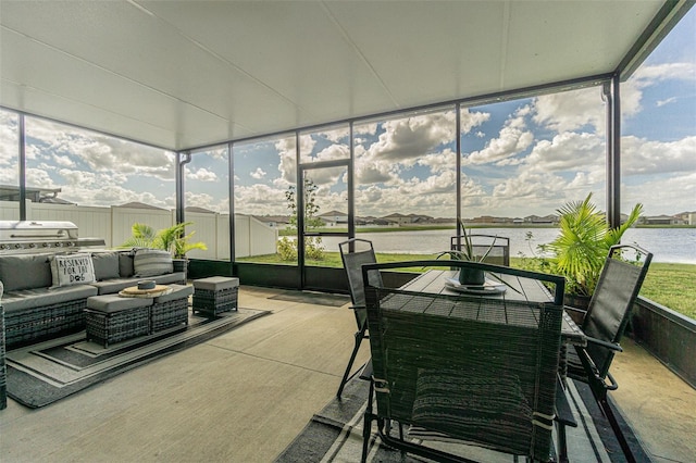 sunroom / solarium with a water view