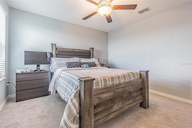 carpeted bedroom featuring multiple windows and ceiling fan