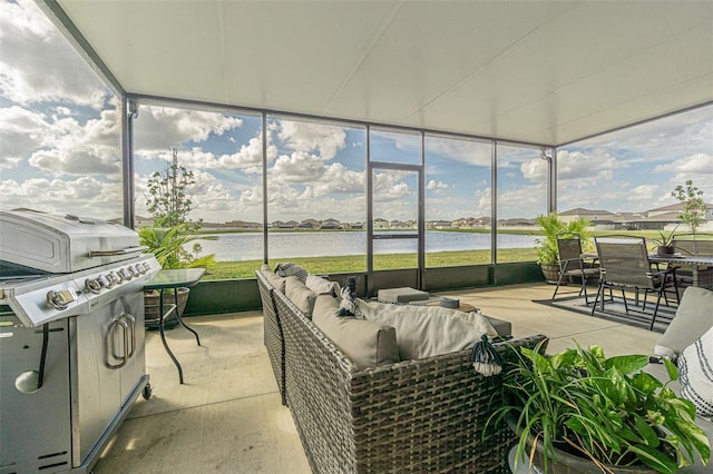 sunroom / solarium featuring a water view