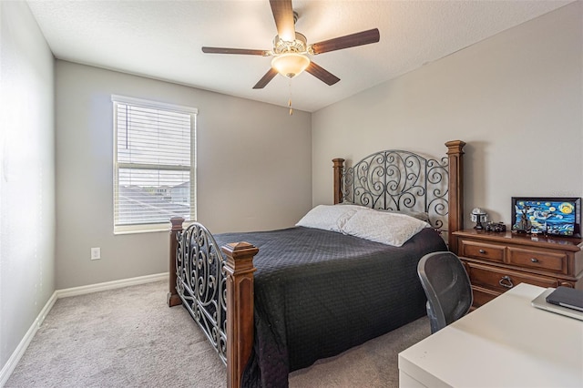 carpeted bedroom featuring ceiling fan and a textured ceiling