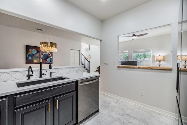 kitchen featuring dishwasher, decorative backsplash, sink, and decorative light fixtures