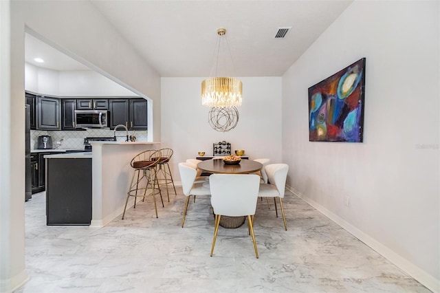 dining space featuring a chandelier