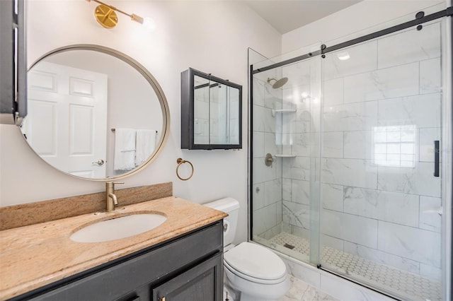 bathroom with a shower with door, vanity, and toilet