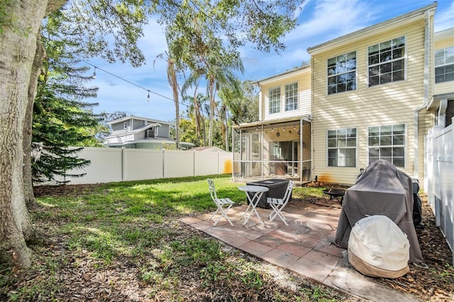 view of yard featuring a sunroom and a patio area