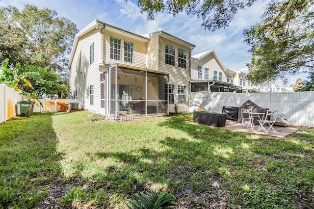 rear view of property with a patio, a sunroom, and a yard