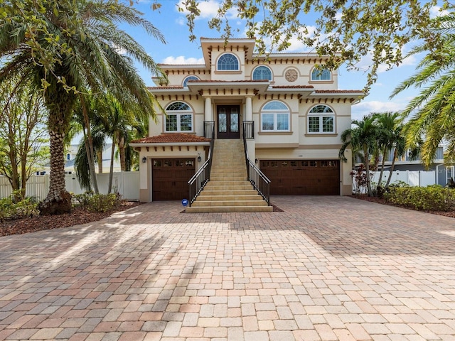 view of front facade with a garage and french doors