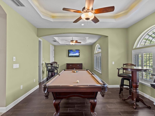 rec room featuring a tray ceiling, ceiling fan, dark hardwood / wood-style flooring, and billiards