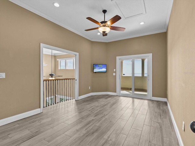 spare room with crown molding, ceiling fan, and light wood-type flooring