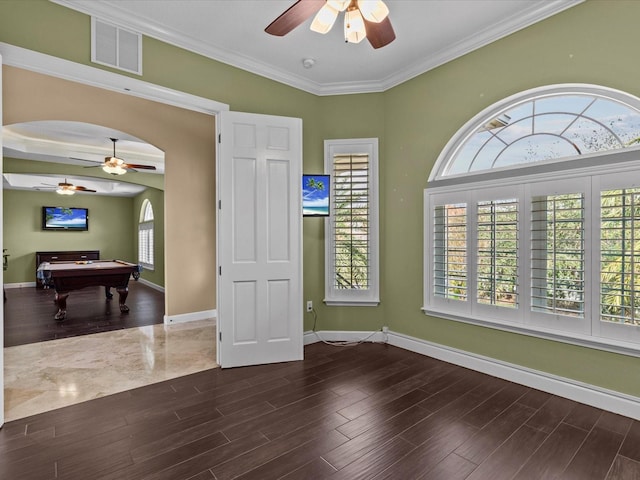 spare room with crown molding, dark hardwood / wood-style floors, and billiards