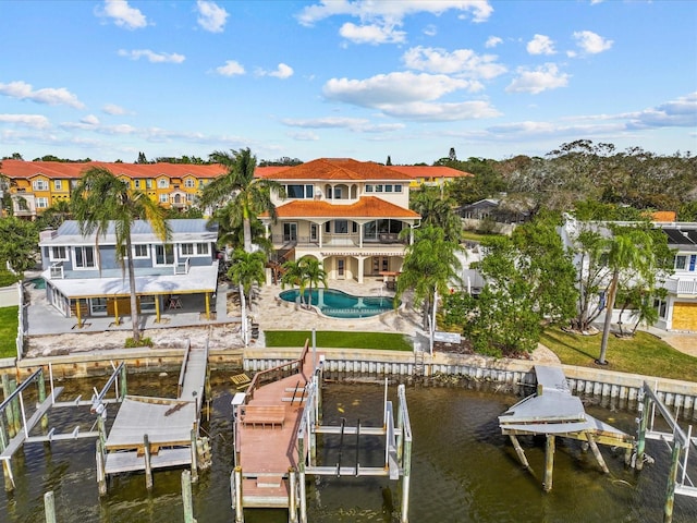 rear view of house featuring a balcony, a water view, and a patio