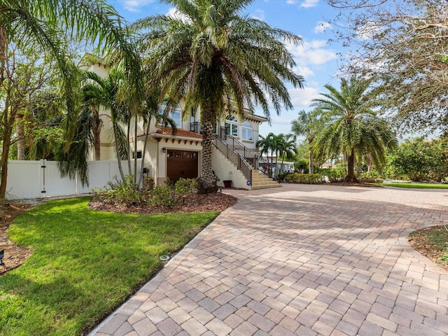 view of front of home featuring a front yard and a garage