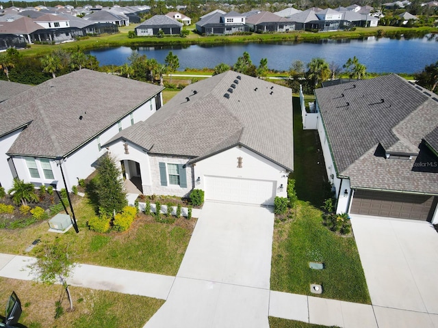 birds eye view of property with a water view