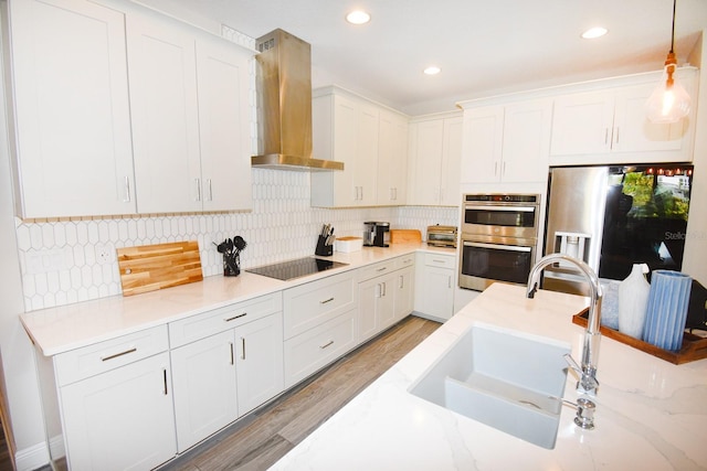 kitchen with white cabinetry, stainless steel appliances, and hanging light fixtures