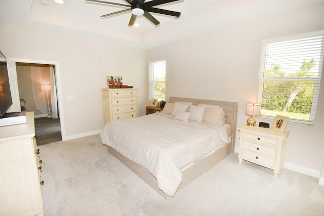 carpeted bedroom with ceiling fan and multiple windows