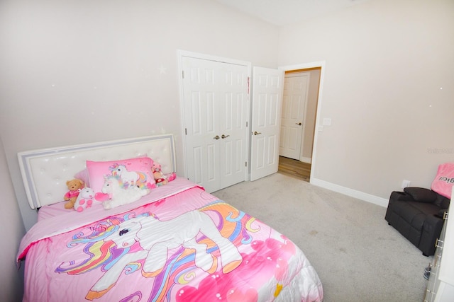 bedroom featuring light colored carpet and a closet