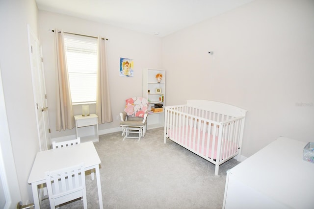 bedroom with carpet flooring and a nursery area