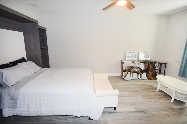 bedroom featuring ceiling fan and wood-type flooring