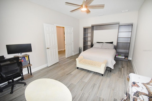 bedroom with light wood-type flooring and ceiling fan