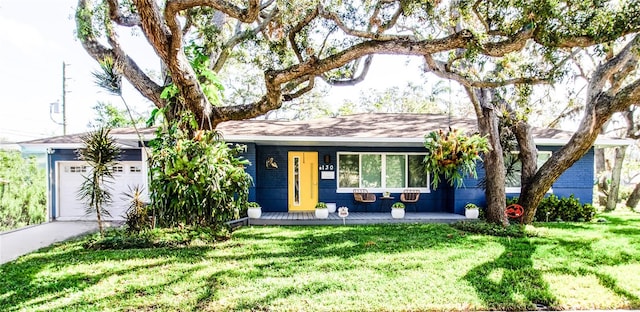 ranch-style house featuring a garage and a front lawn