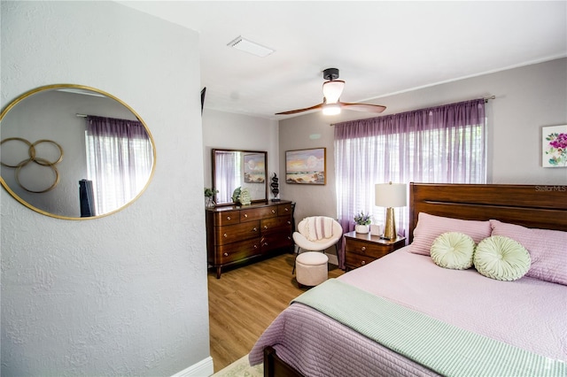 bedroom with light hardwood / wood-style floors and ceiling fan