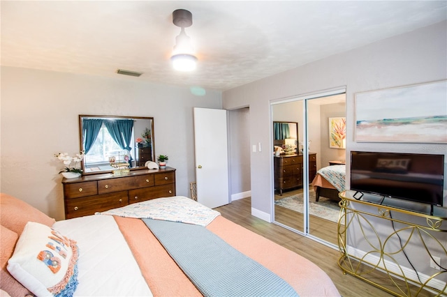 130 63rd St S, Saint Petersburg, FL 33707 - bedroom featuring light wood finished floors, a closet, and baseboards