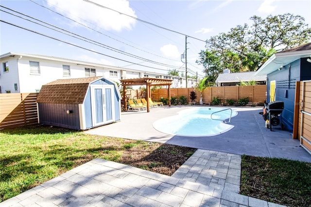 view of pool featuring a shed, area for grilling, a pergola, and a patio area