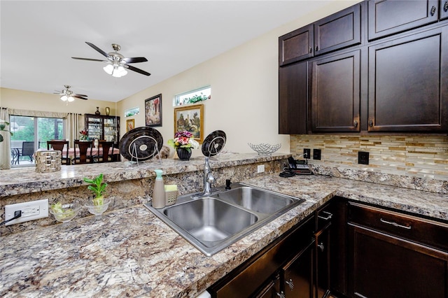 kitchen with sink, tasteful backsplash, dark brown cabinets, kitchen peninsula, and ceiling fan